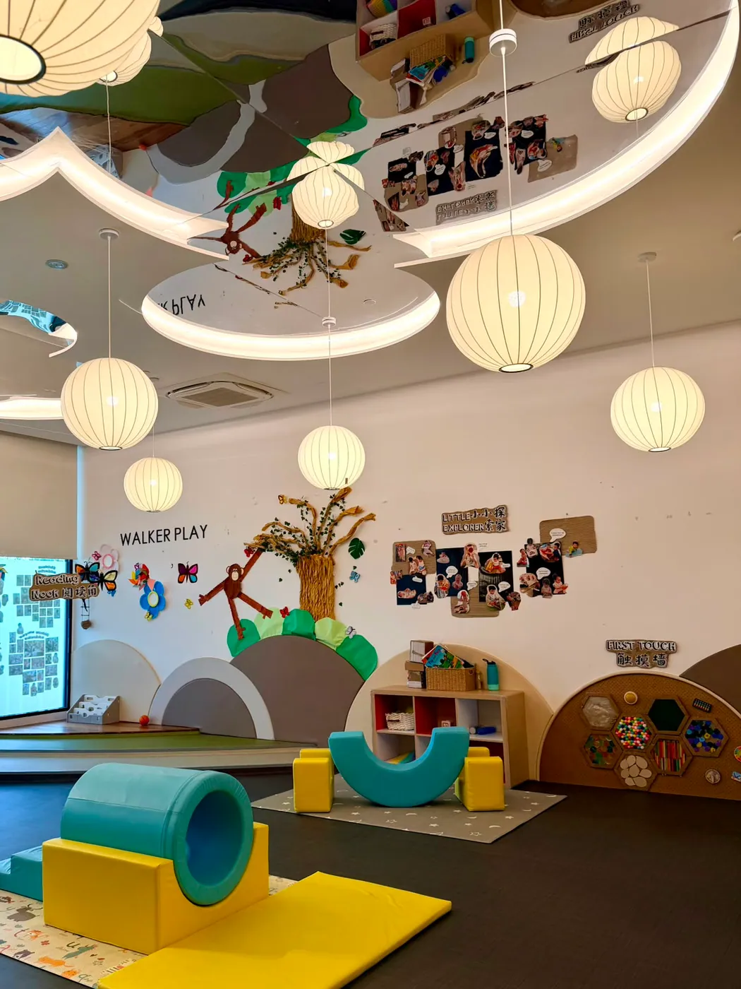 The infant Walker Play room with a tree mural, soft play shapes and the First Touch sensory wall