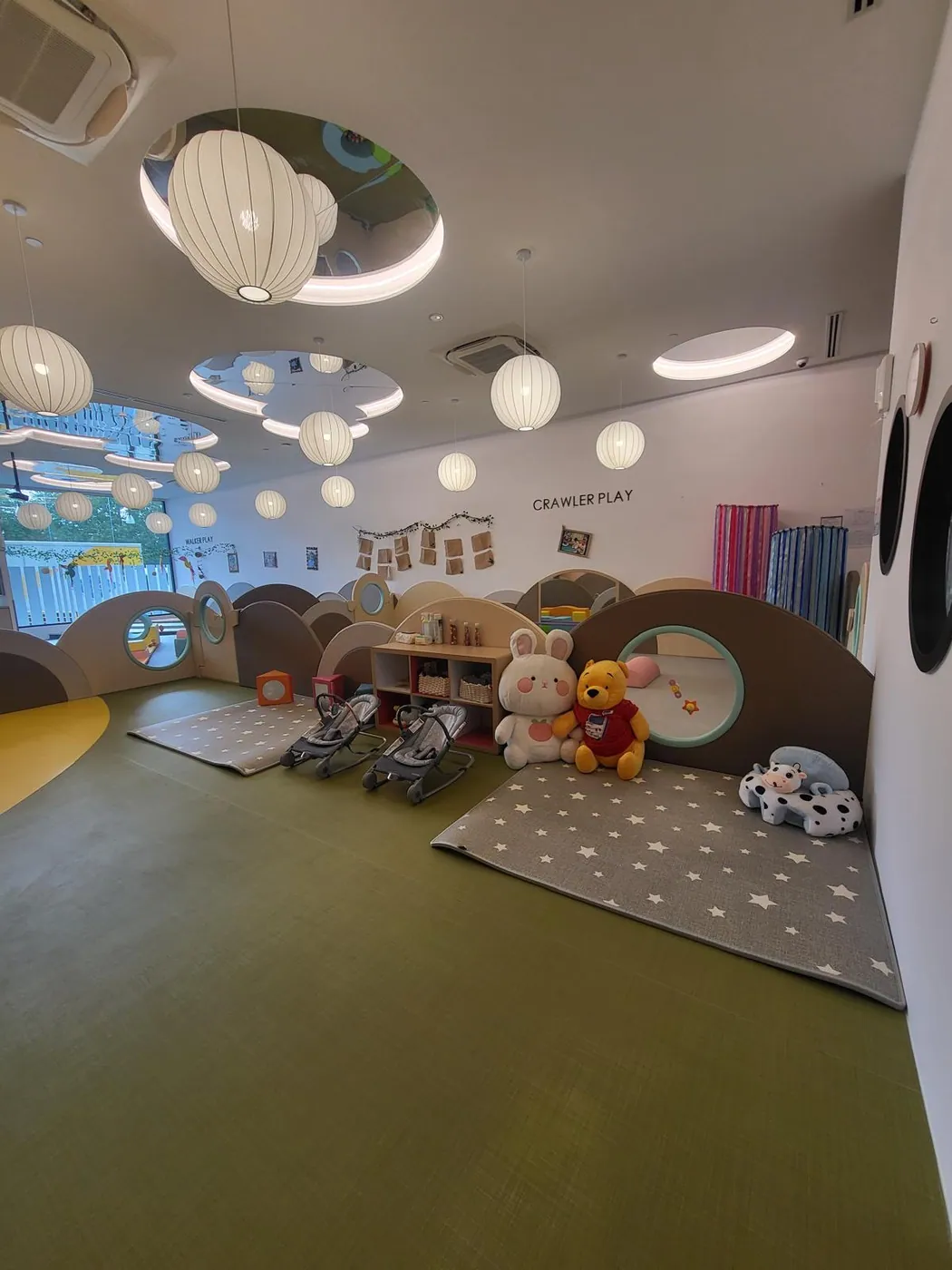 A soft, cosy infant crawler play room with plush toys and gentle lighting