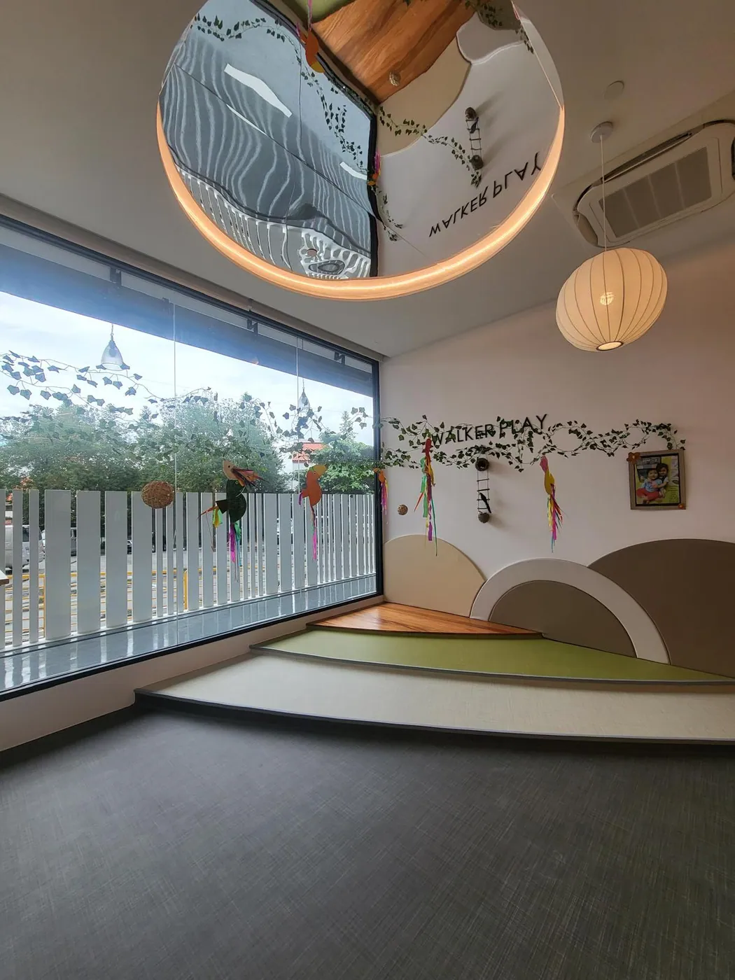 The Walker Play window nook with a soft raised platform and greenery